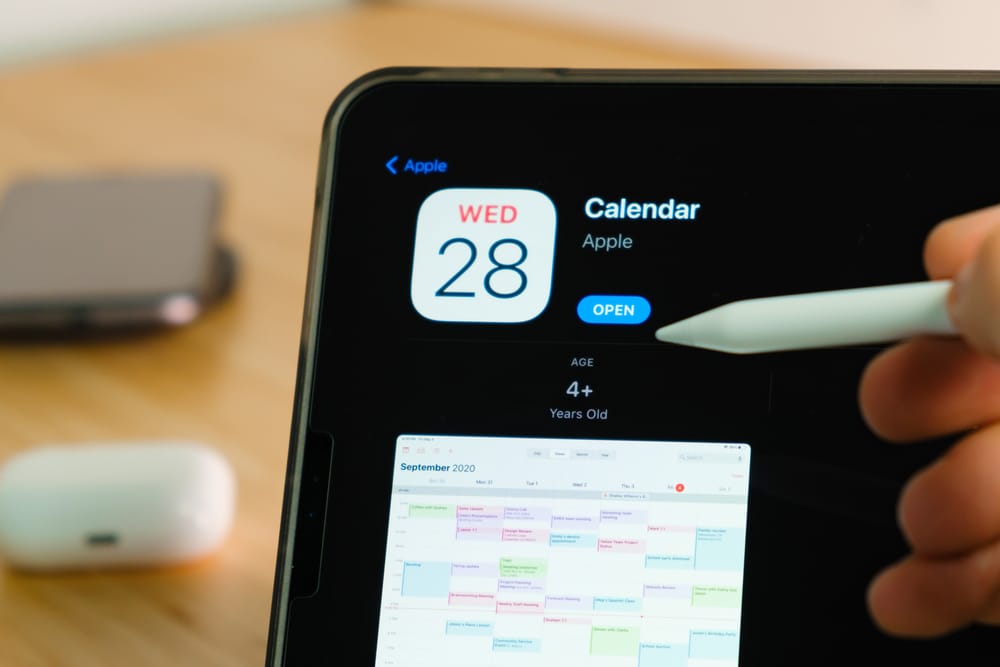 Lawyer using a stylus on an iphone editorial calendar